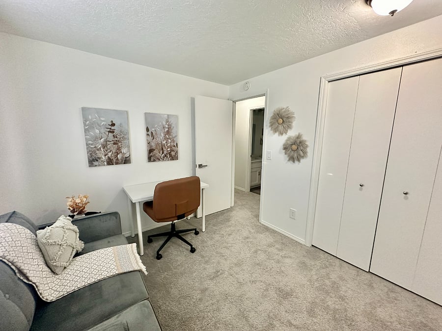 Designated workspace that has a futon couch/bed (full size) and a working desk.
