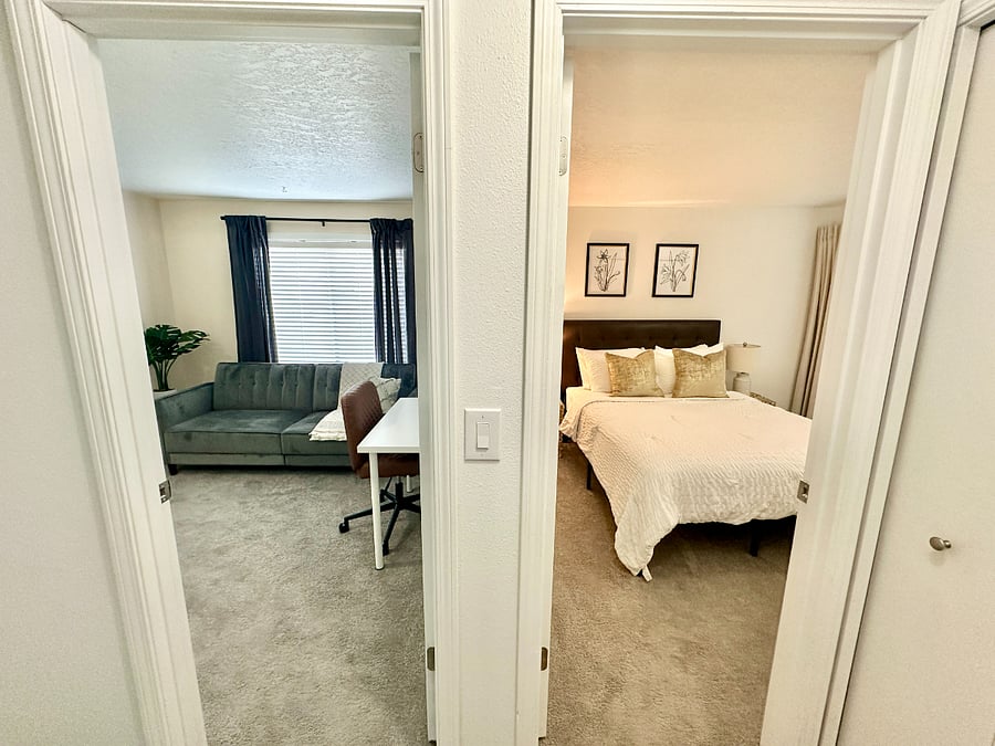 Designated workspace that has a futon couch/bed (full size) and a working desk.