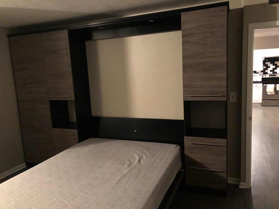Main Bedroom - Queen Size Murphy Bed, Memory Foam Mattress with side tables, light, and storage.