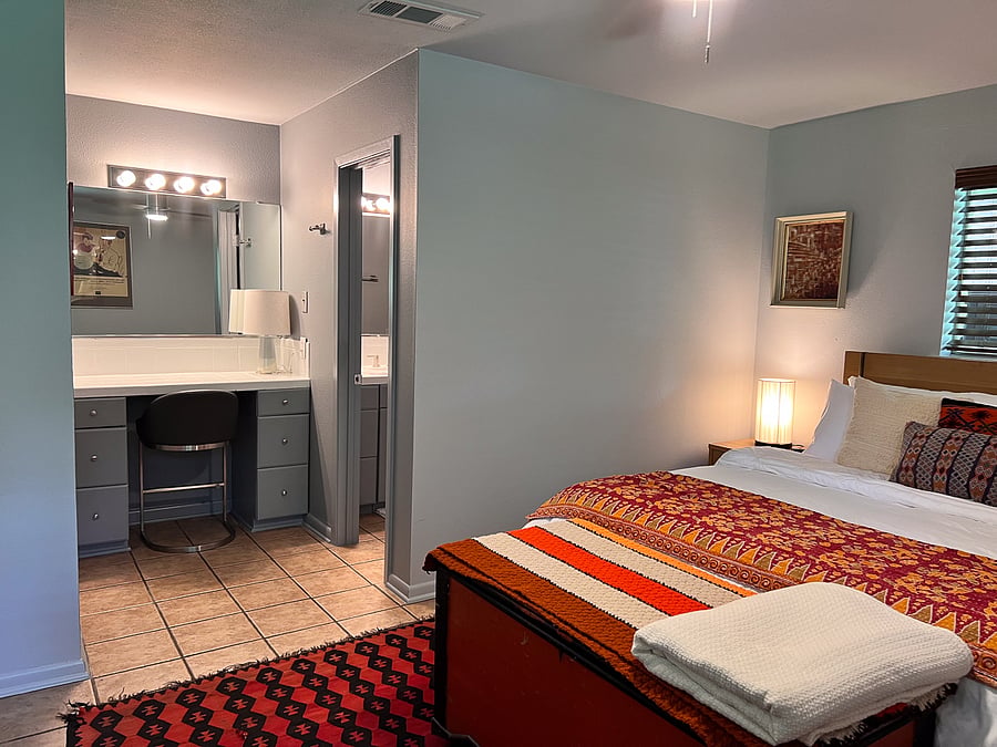 Primary bedroom with built in vanity.