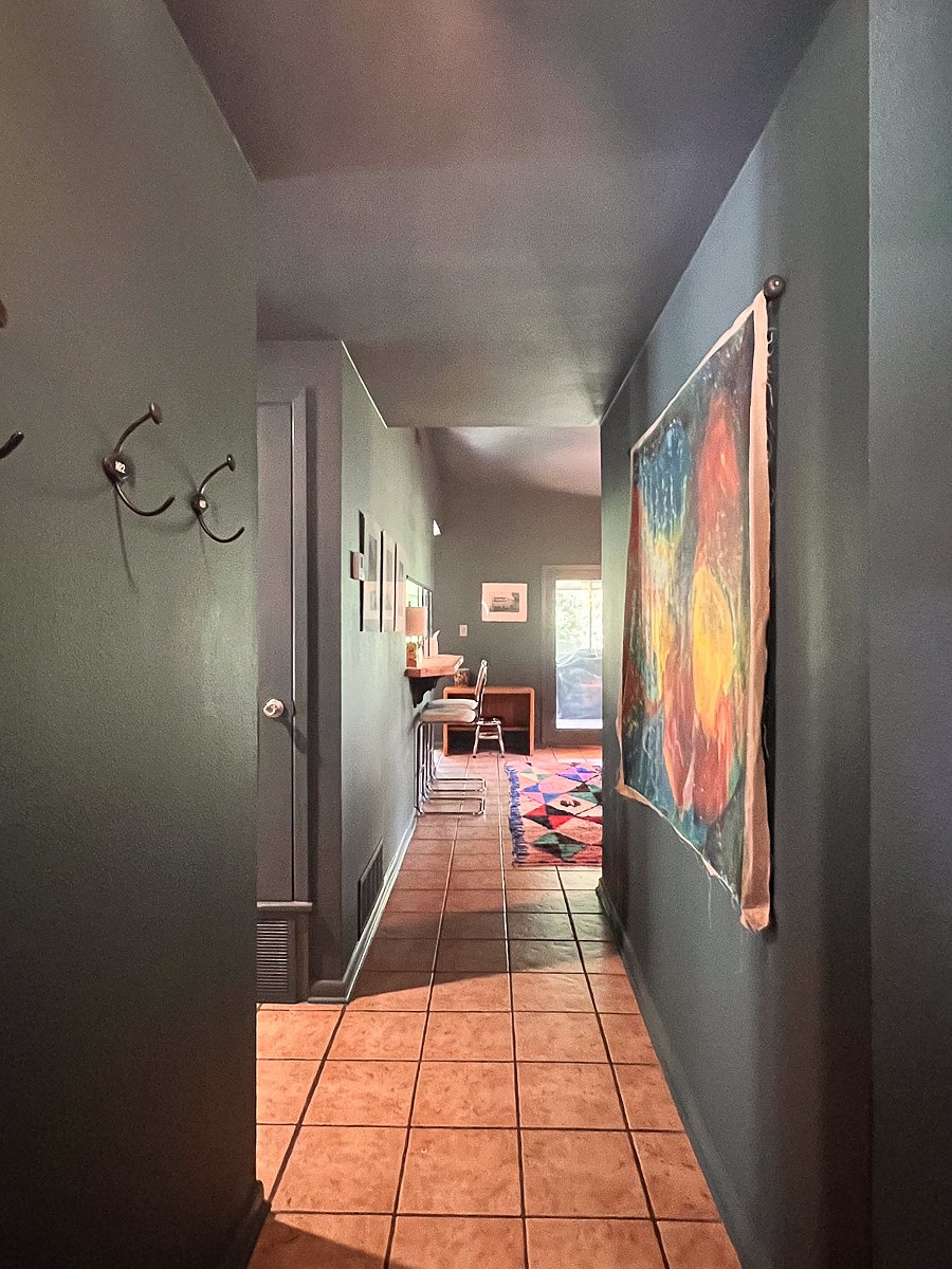 Front door entrance into the heart of the house with 2nd bathroom and 2 guest rooms off to the right.