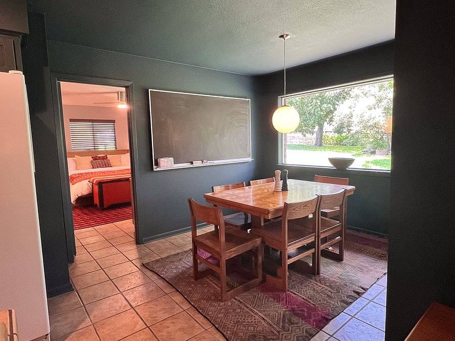 Dinning area with primary bedroom/bathroom in background.
