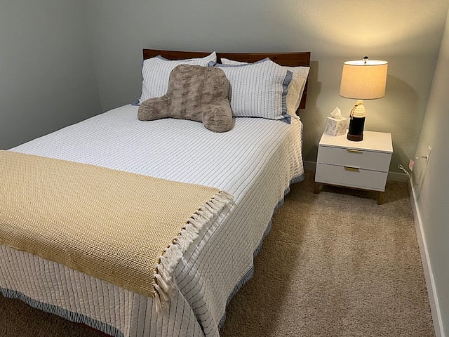 Secondary bedroom upstairs with large closet and queen bed.