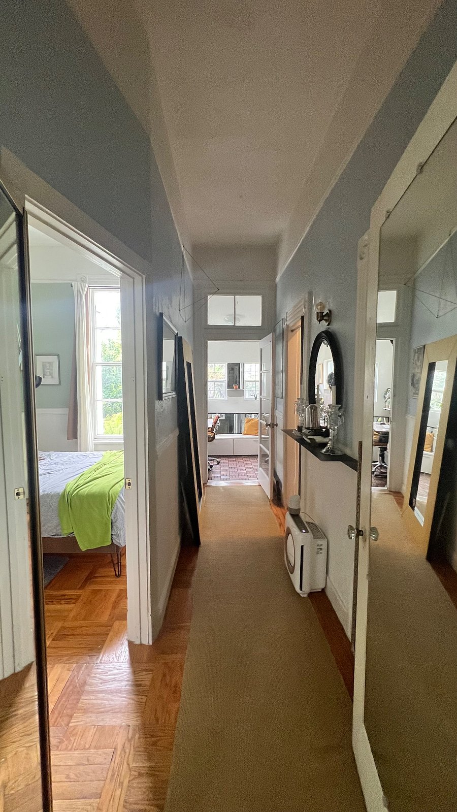 Here is the hallway that leads you to the back portion of the apartment. On the left is my room, center is the back office/storage area that takes you to the yard downstairs. To the right is the kitchen.