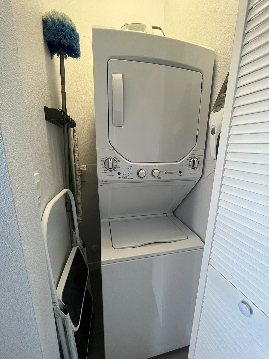 The washer and dryer are in-unit between the bedroom and bathroom.