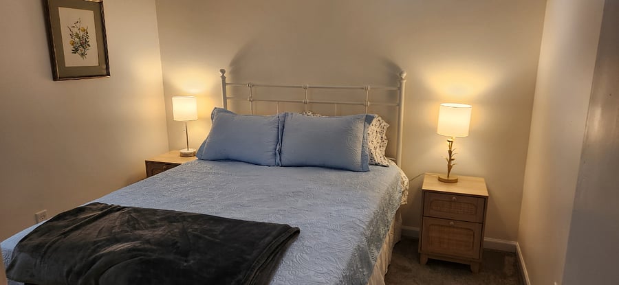 Second bedroom with queen bed perfect for guests, family, or additional workspace.