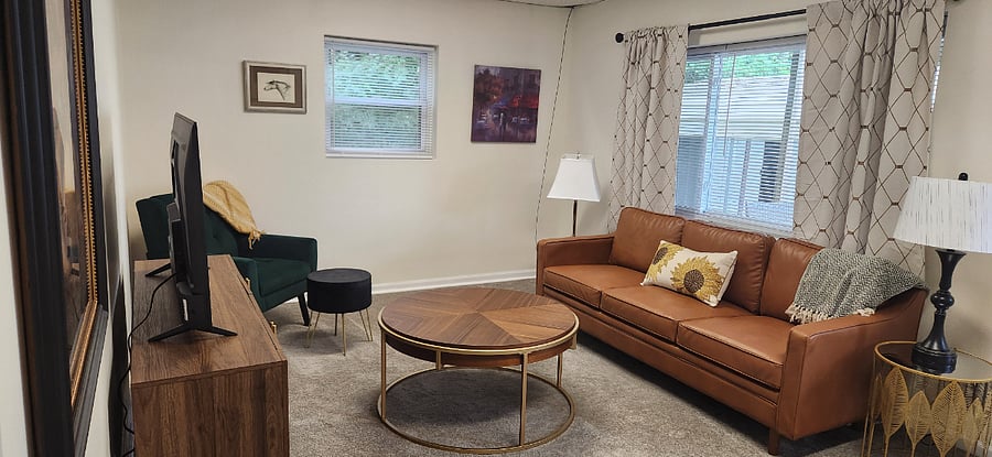 Cozy living room with smart TV and comfortable seating perfect for relaxing after work.