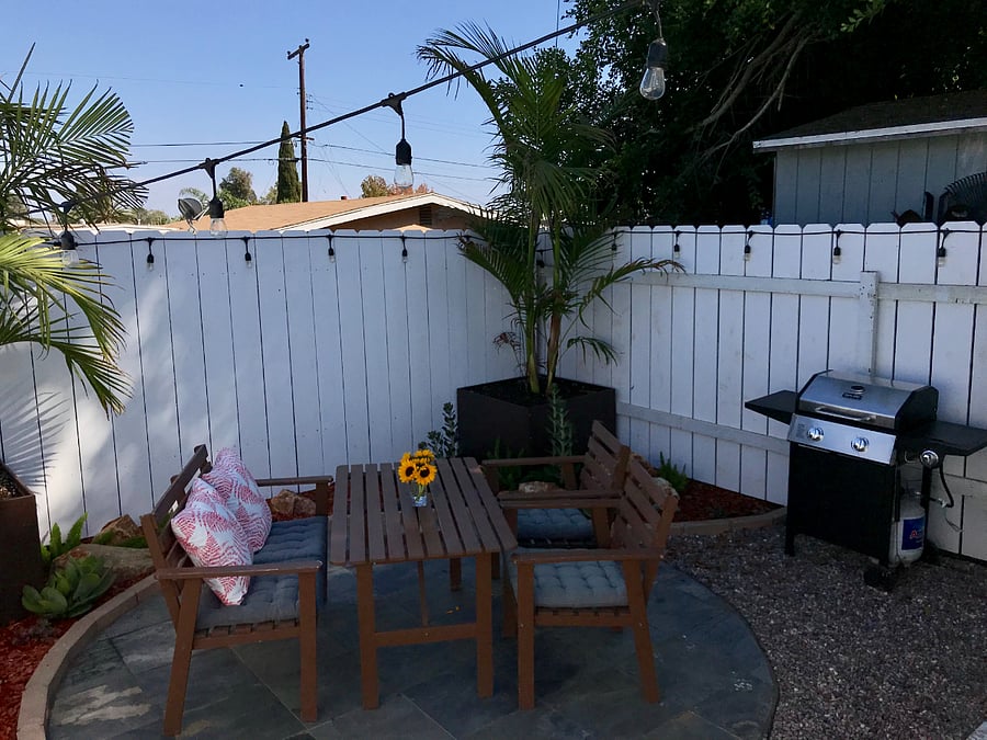 Private backyard with outdoor table and barbeque
