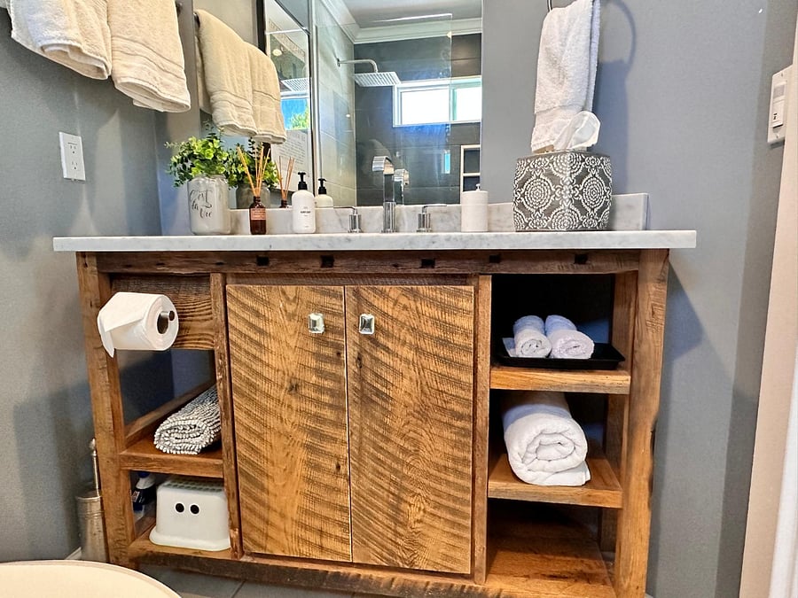 Carrara marble countertop and custom reclaimed wood vanity