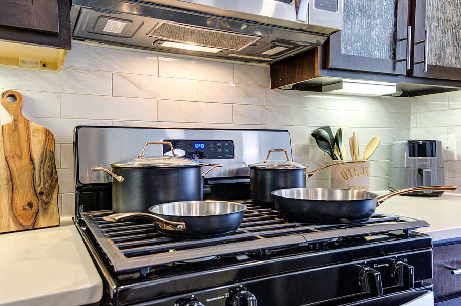 Stainless pots, gas stove, and air fryer.