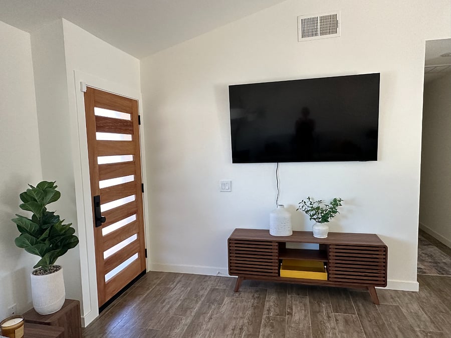 Front door into living room with 60-in Samsung Smart TV