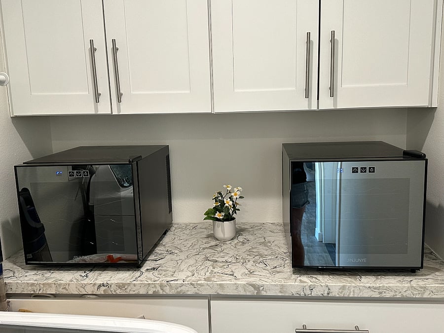 Two 12-bottle wine fridges, one for red and one for white. 
