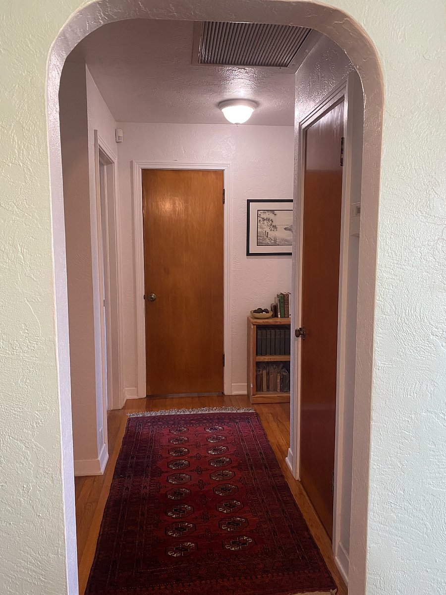 Hallway with linen closet (towels, beach towels etc) and laundry basket. Bedroom to the right