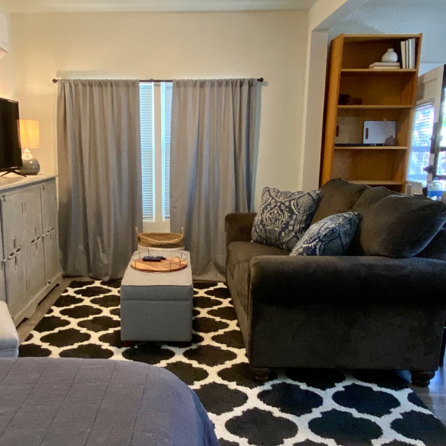 Living area with comfy loveseat and smart tv with Roku.