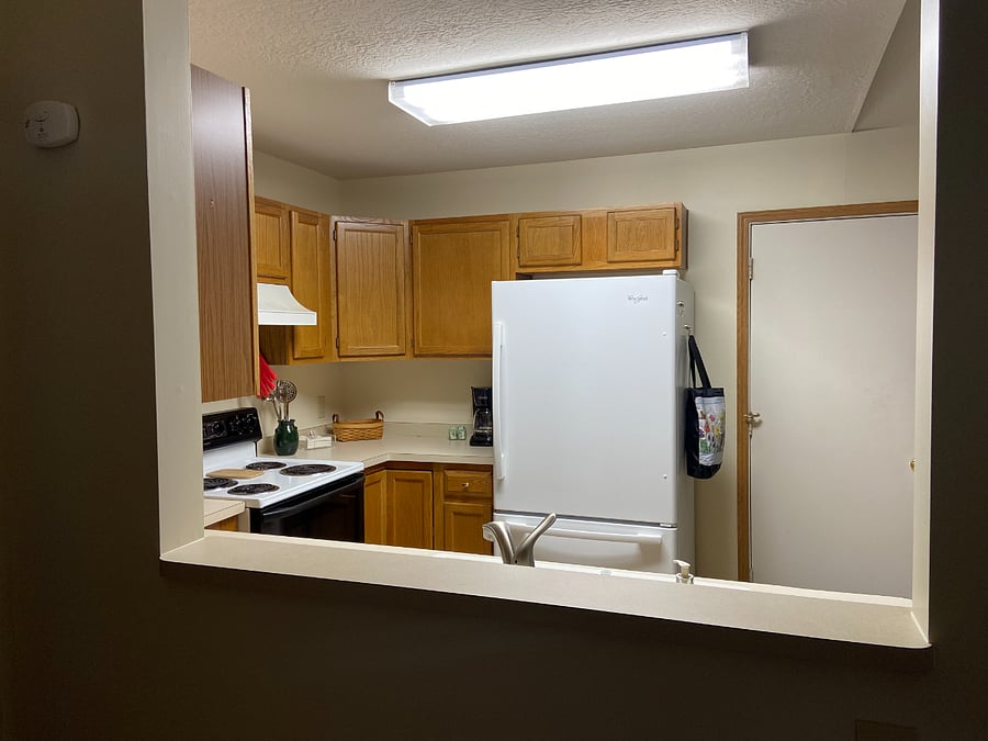 Kitchen looking thru window from living area for more open feel