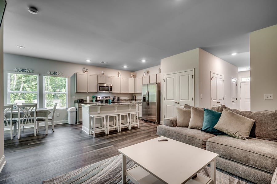 "Cozy meets convenience! Kick back on the comfy sofa, grab a snack at the kitchen island with bar seating, or head out the door to your 1-car garagethis space has it all!"