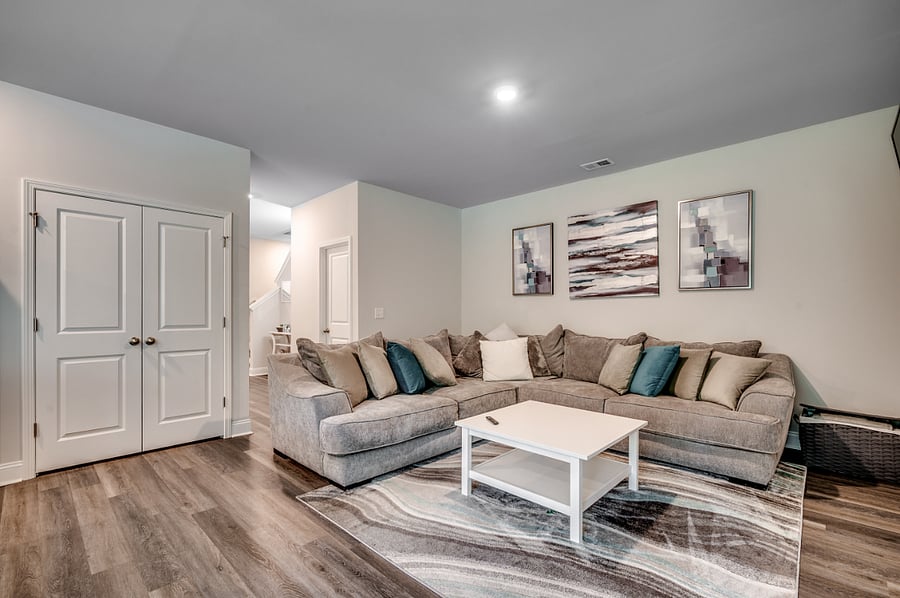 Cozy L-shaped sofa perfect for lounging, paired with a chic coffee table in the main floor living area.