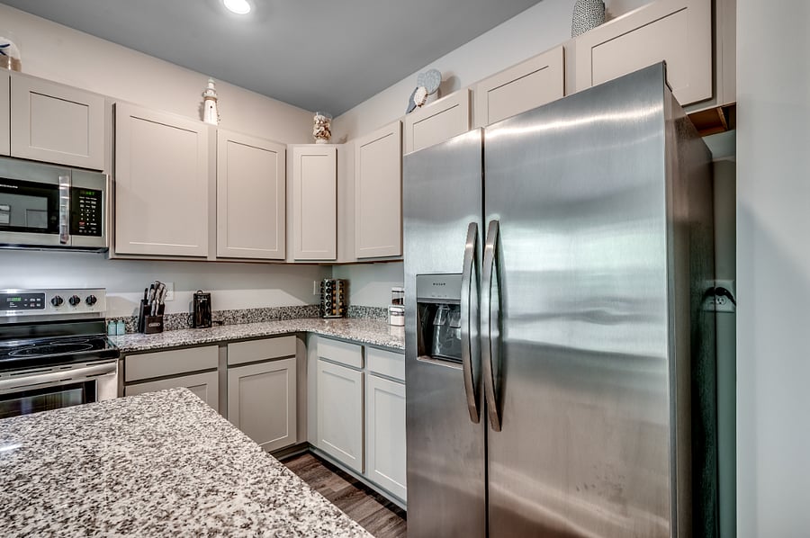 Shiny fridge with built in water and ice dispenser. Plenty of room for beverage and all your goodies!