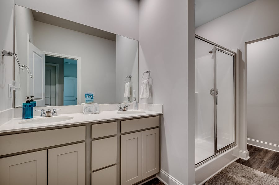 Expansive master bathroom featuring a walk-in shower and dual sinks for a touch of luxury.