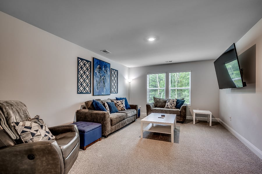 Spacious upstairs loft with a pull-out sofa, ample soft seating, and a huge smart TVideal for video games, football games, or just lounging around.