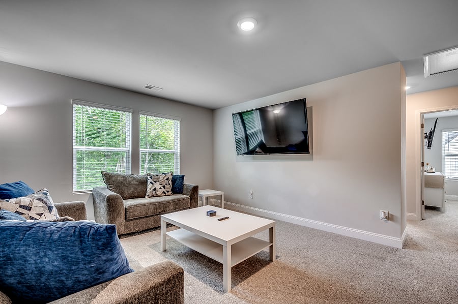 Spacious upstairs loft with a pull-out sofa, ample soft seating, and a huge smart TVideal for video games, football games, or just lounging around.