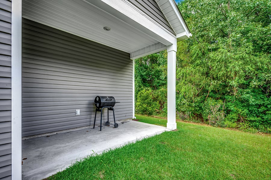 Back patio featuring a charcoal grillperfect for outdoor cooking and dining.