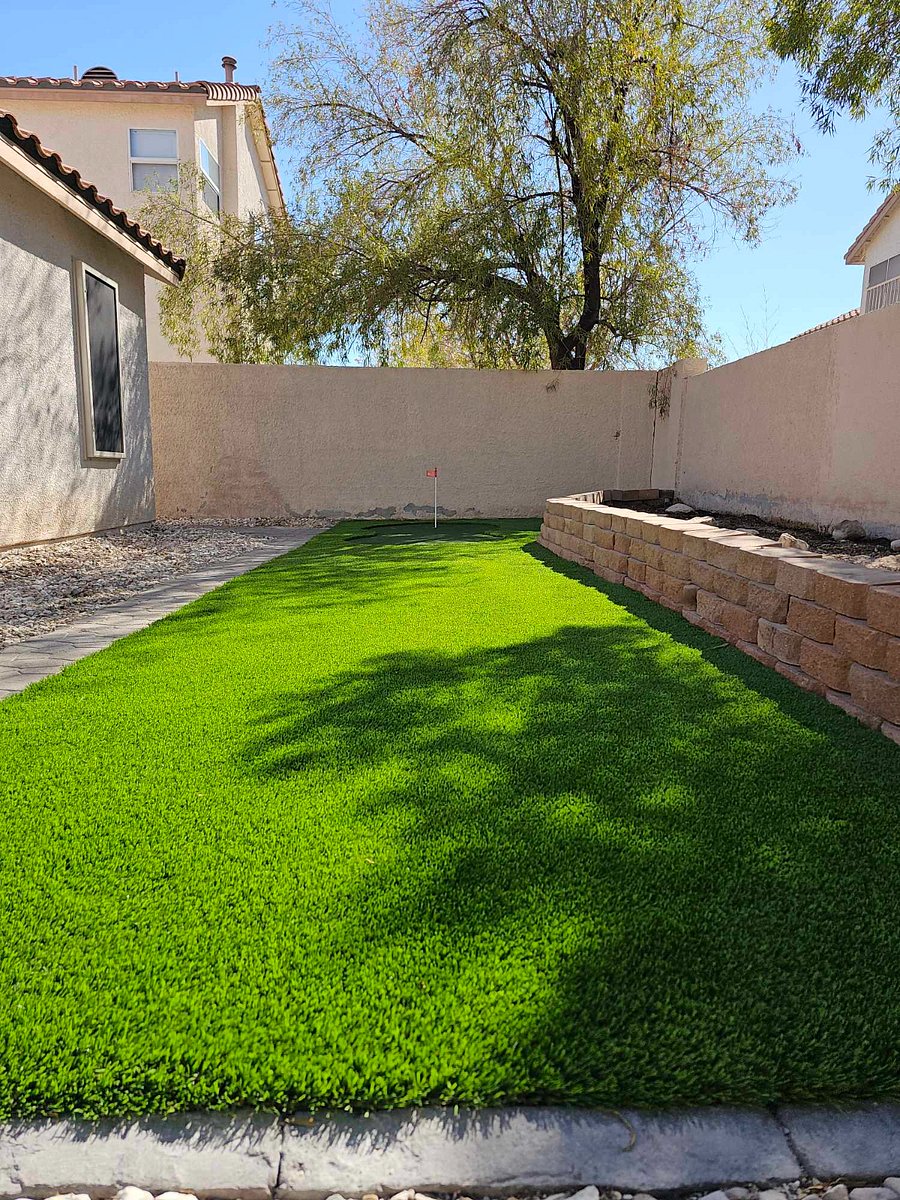 Private enclosed yard with turf and putting green