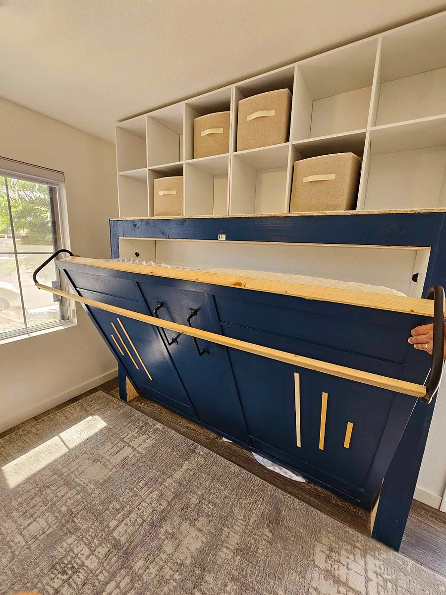 Full size memory foam bed. Custom Murphy bed system with overhead storage.