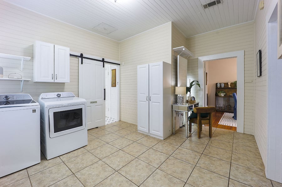 New large-capacity LG smart washer and dryer and dedicated workspace for a laptop.