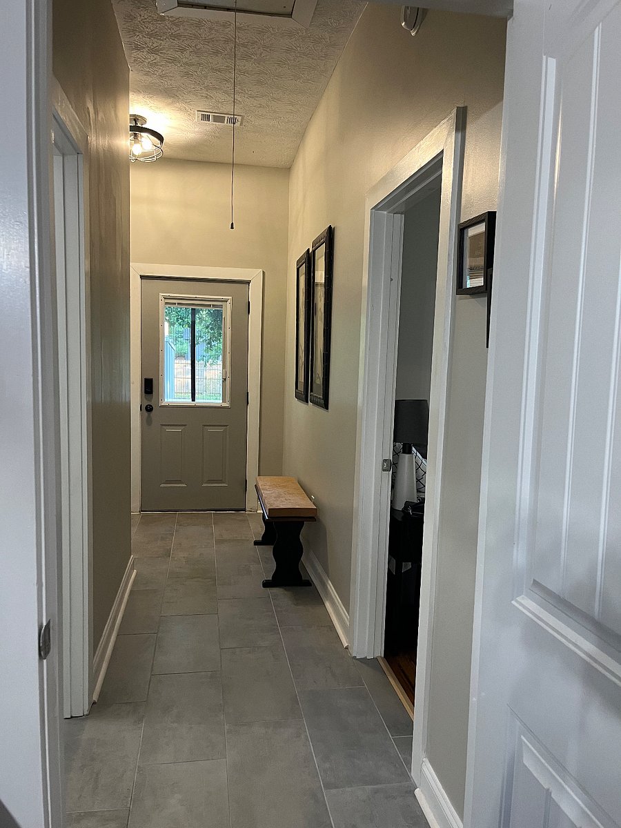 Hallway to back door, bathroom on the right, master bed room on the right.