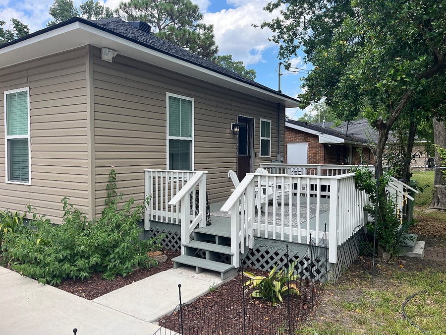 Back porch with access to the driveway. Two Adirondack chairs to enjoy the birds, evening breeze or morning coffee. Motion sensor lights on all corners of the house for late night arrival/departures.