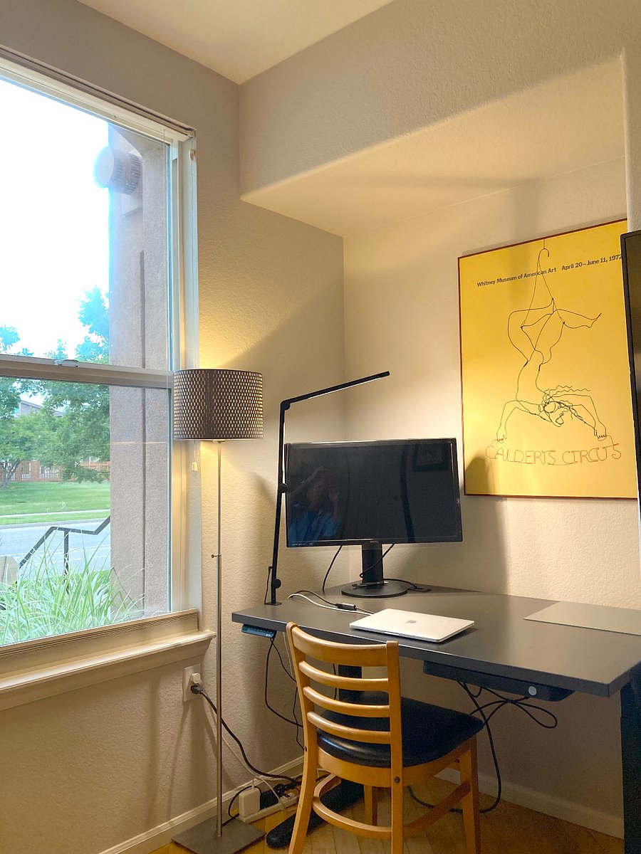 The workspace in the corner of the livingroom has a large sit/stand desk and large monitor with HDMI cable.
