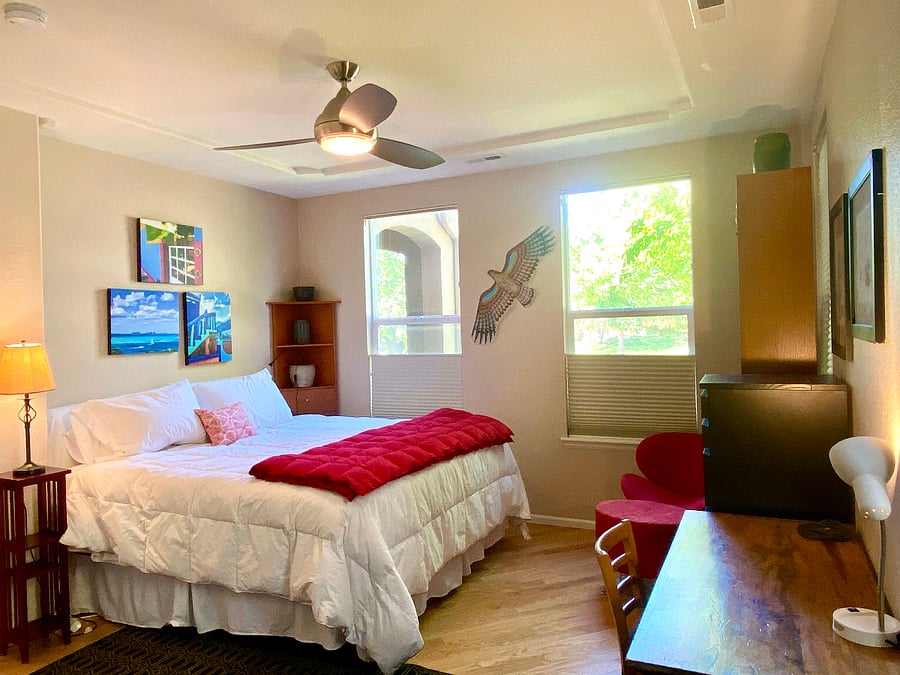 The master bedroom has an attached bath and table that offers an additional work space.
