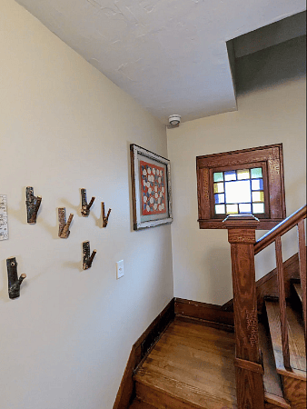 Stairwell with original woodwork and stained glass