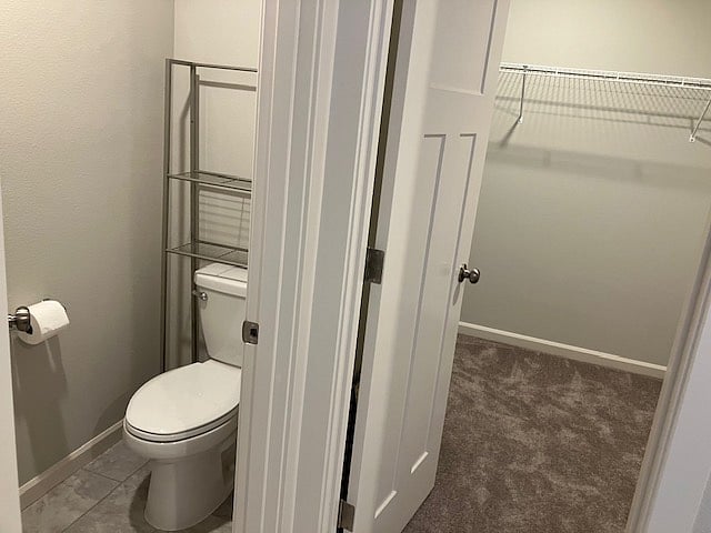 primary bedroom toilet room next to large closet 