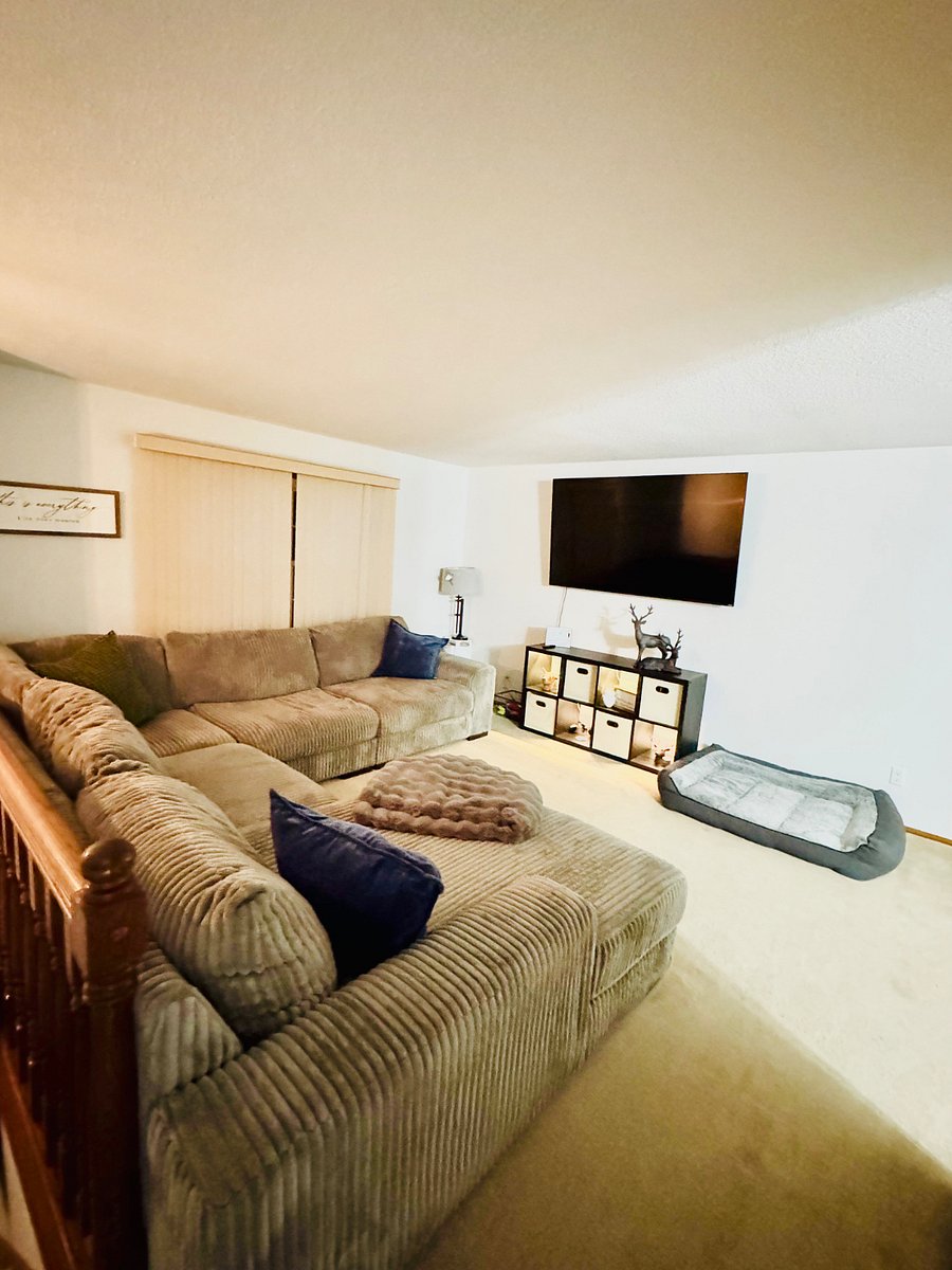 Very cozy living space with a large sectional and 75 TV