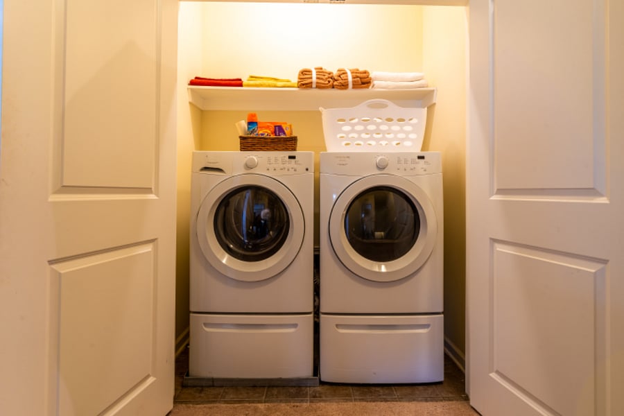 Full capacity washer and dryer located on the third level.