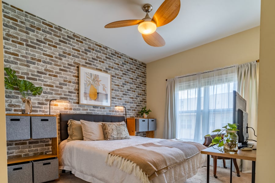 Urban style second bedroom with a queen size bed on the third level.