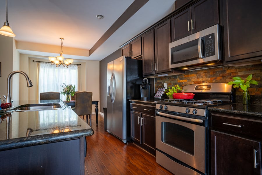 Spacious open concept kitchen on the second level. with full size range refrigerator and dishwasher.