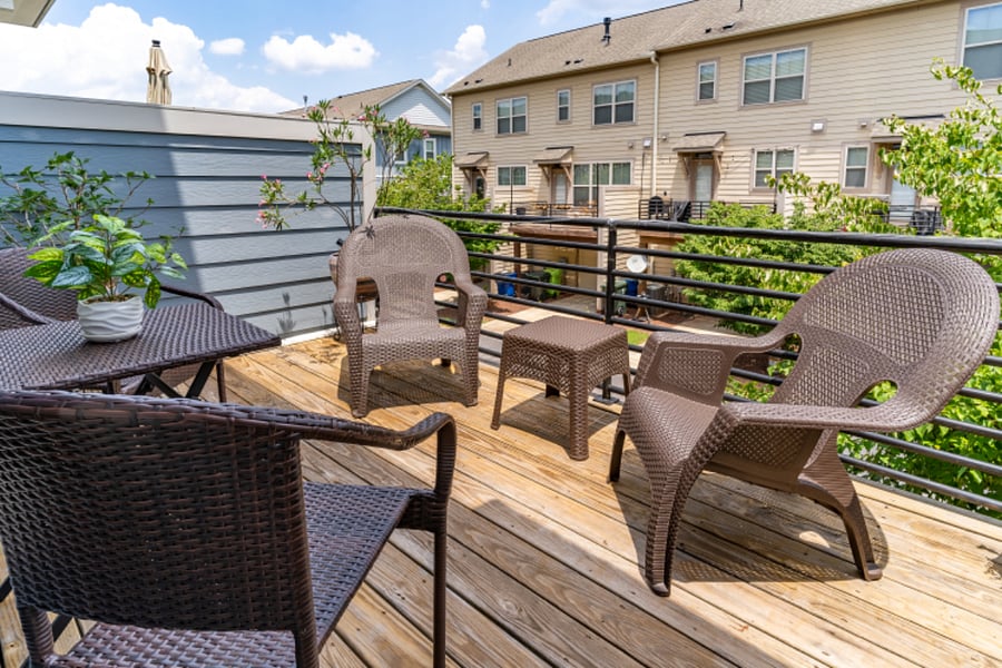Exterior deck that gets plenty of sun and is located above the exterior parking space.