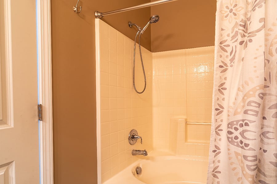 Master bathroom shower w/ shower head that has an extended hose.. 