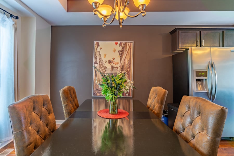 Dining area comfortably seats 6 people with additional folding chairs located on the first level of home.
