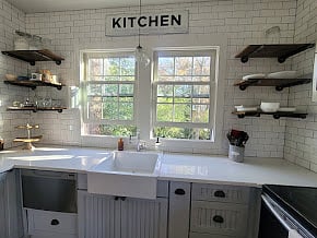 Kitchen w/ Farmhouse sink and open shelving
