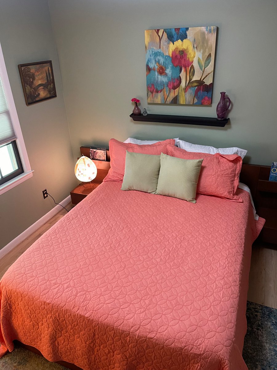 Slide into slumber within the sedate sage green walls of Bedroom 2, featuring a supple queen sized bed and a relaxed, mid-century vibe. Theres plenty of privacy in Bedroom 2, with ample drawer space for all your traveling needs.