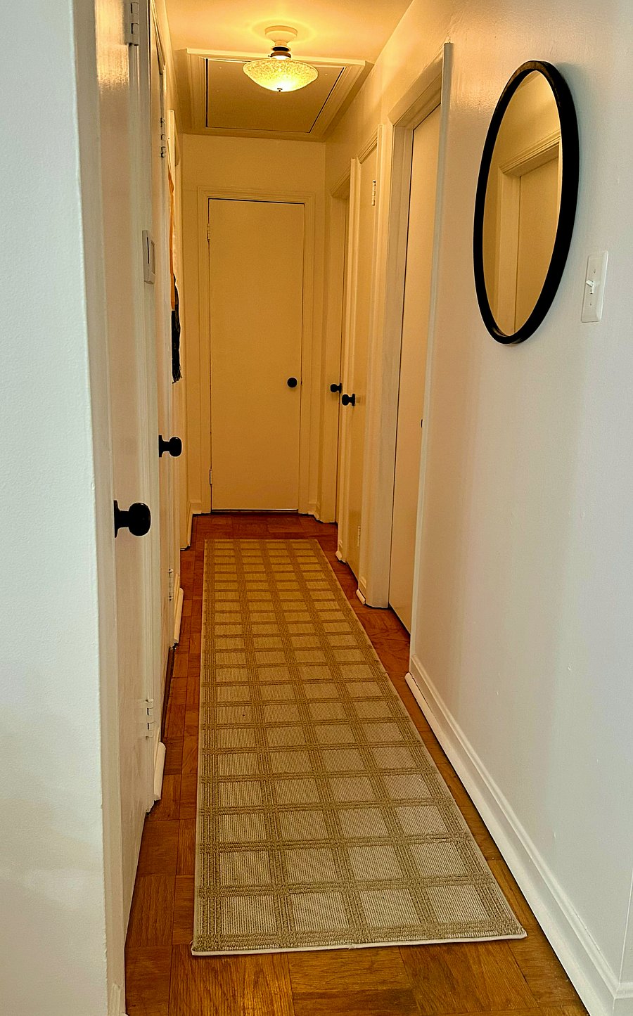 hallway with coat closet and linen closet