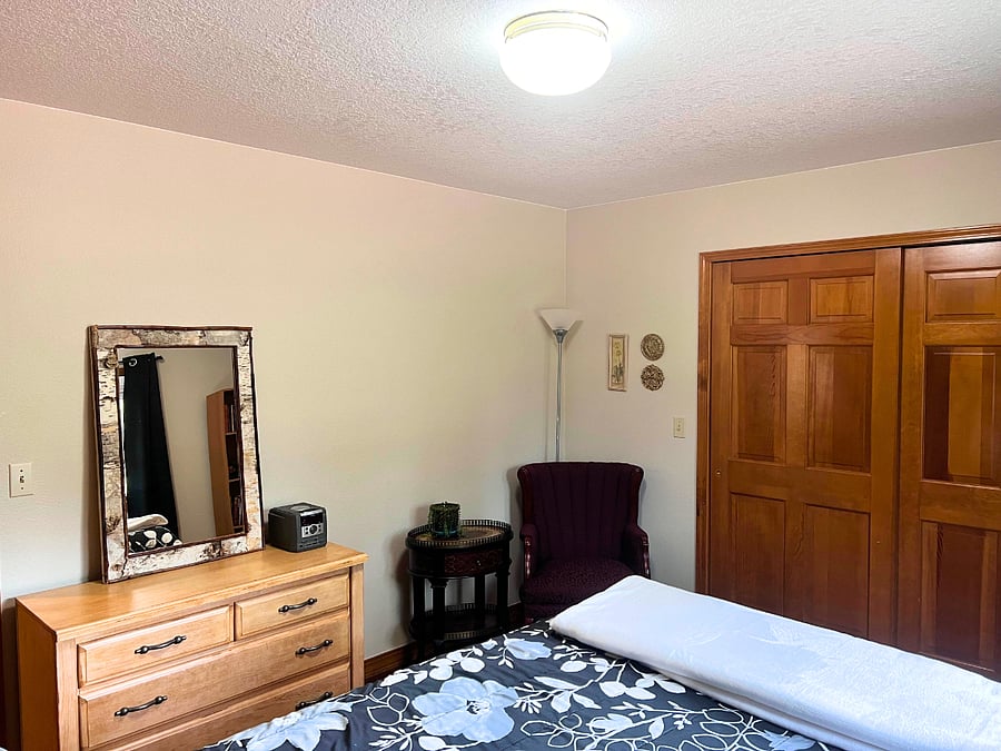 Bedroom 1. Dresser, chair, and side table.  Nice closet for all of your belongings