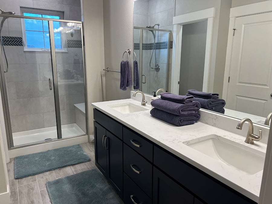 Primary bath with attached water closet and walk in shower, featuring dual Jack and Jill sinks. Large, oversized walk in closet located to the right.