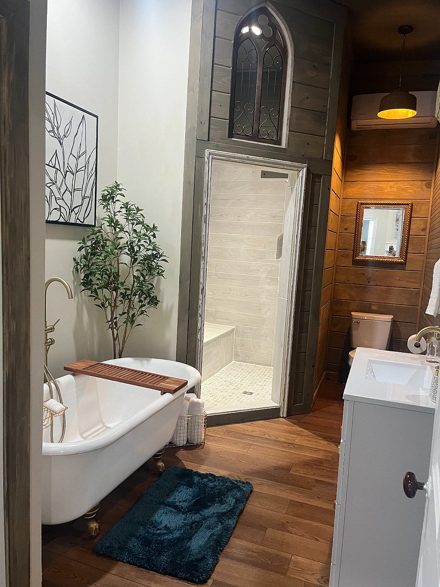 Main bathroom with large walk in shower and original claw foot tub.