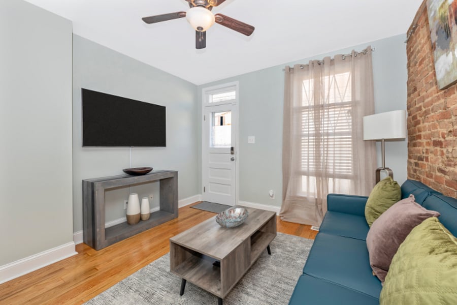 Living room with TV & Roku. Room darkening curtains & film on windows for privacy.