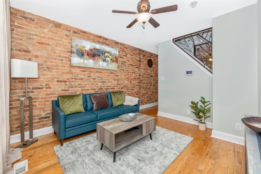 Living room with TV & Roku. Room darkening curtains & film on windows for privacy.